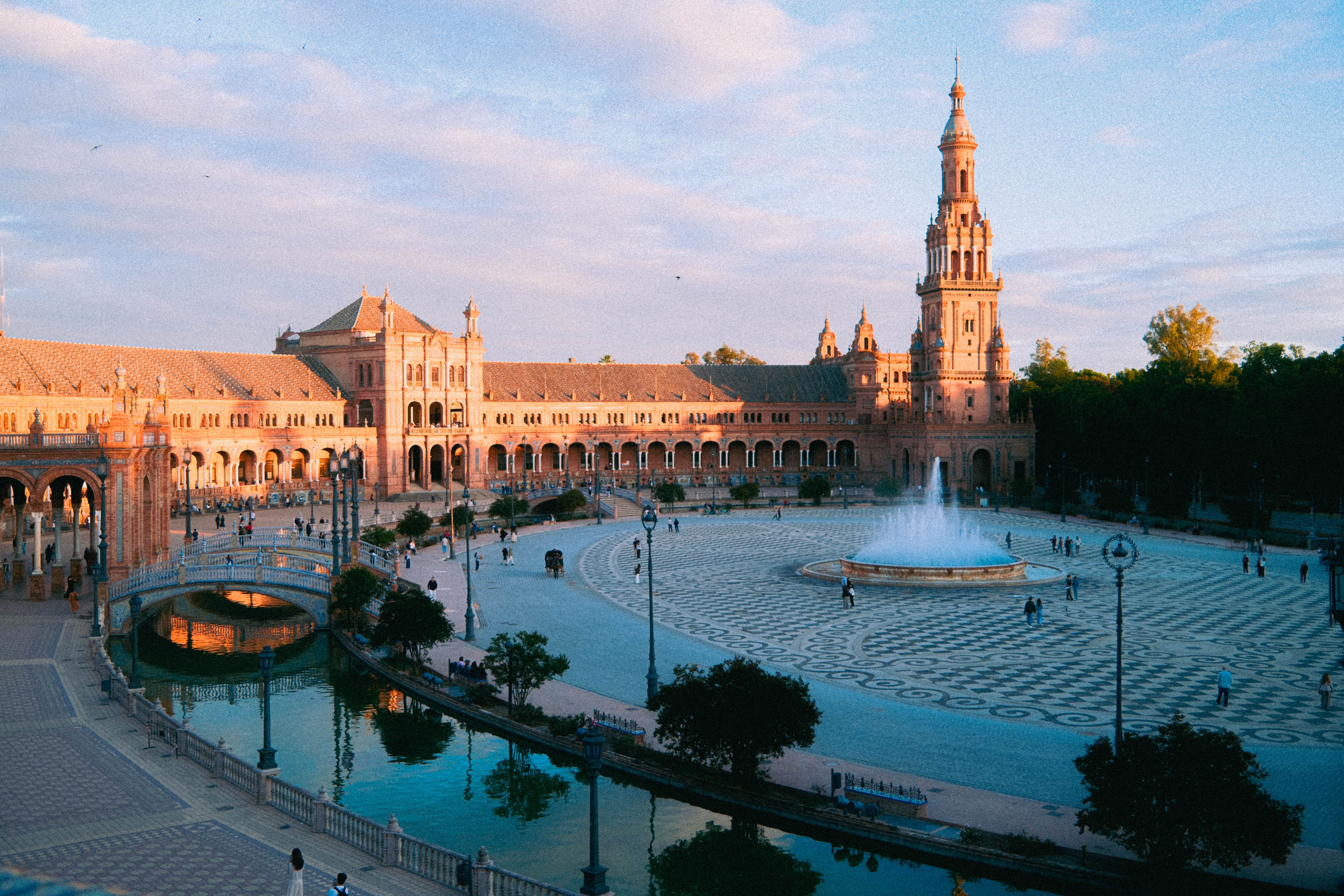 vibrant Spanish plaza at sunset with locals and expats mingling