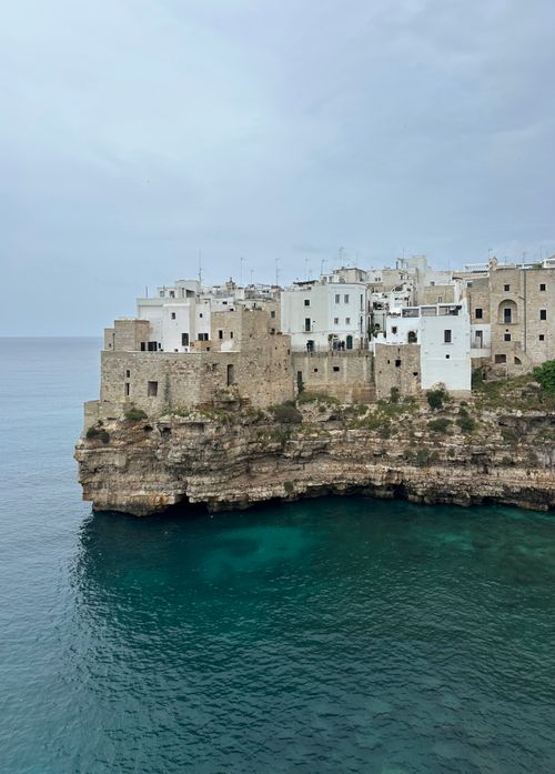 Free Captivating view of Polignano a Mare's whitewashed buildings perched on cliffs overlooking the Adriatic Sea. Stock Photo