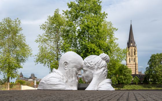 A romantic sculpture set against the historic architecture and lush greenery of Sittard, Limburg.