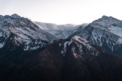 Free Breathtaking view of snow-covered mountains during winter sunset in the Pyrenees, Occitanie region, France. Stock Photo