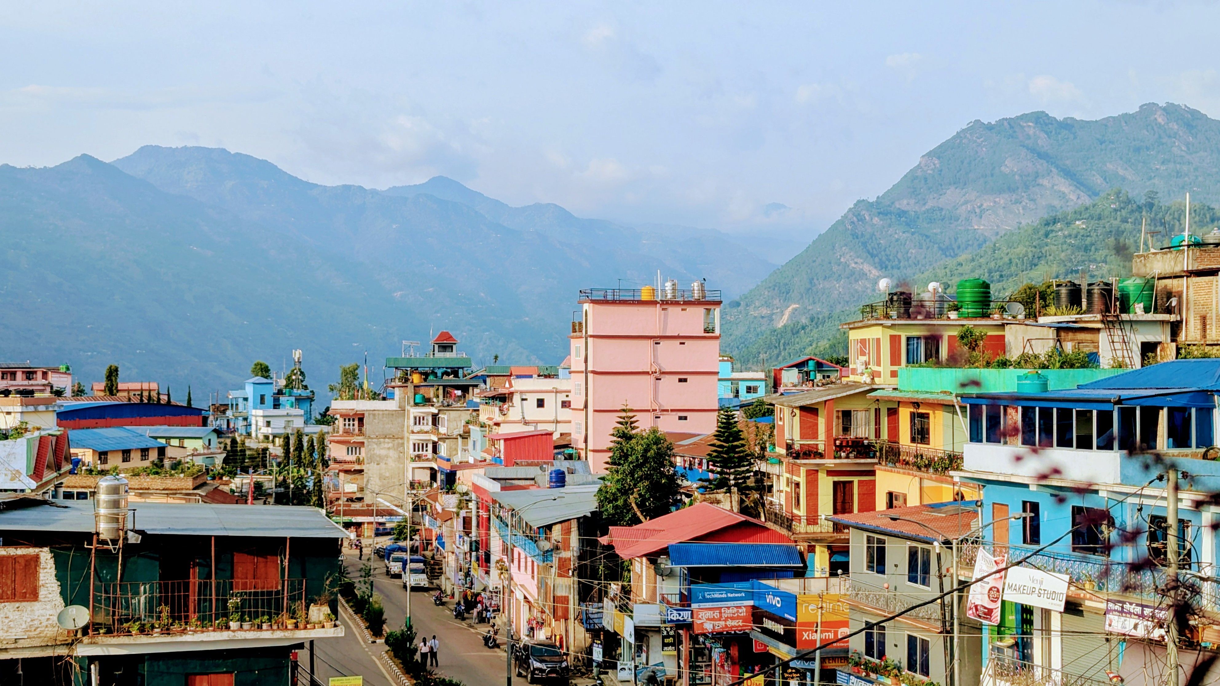 Vibrant view of Phidim, Nepal with vivid buildings and mountain backdrop.