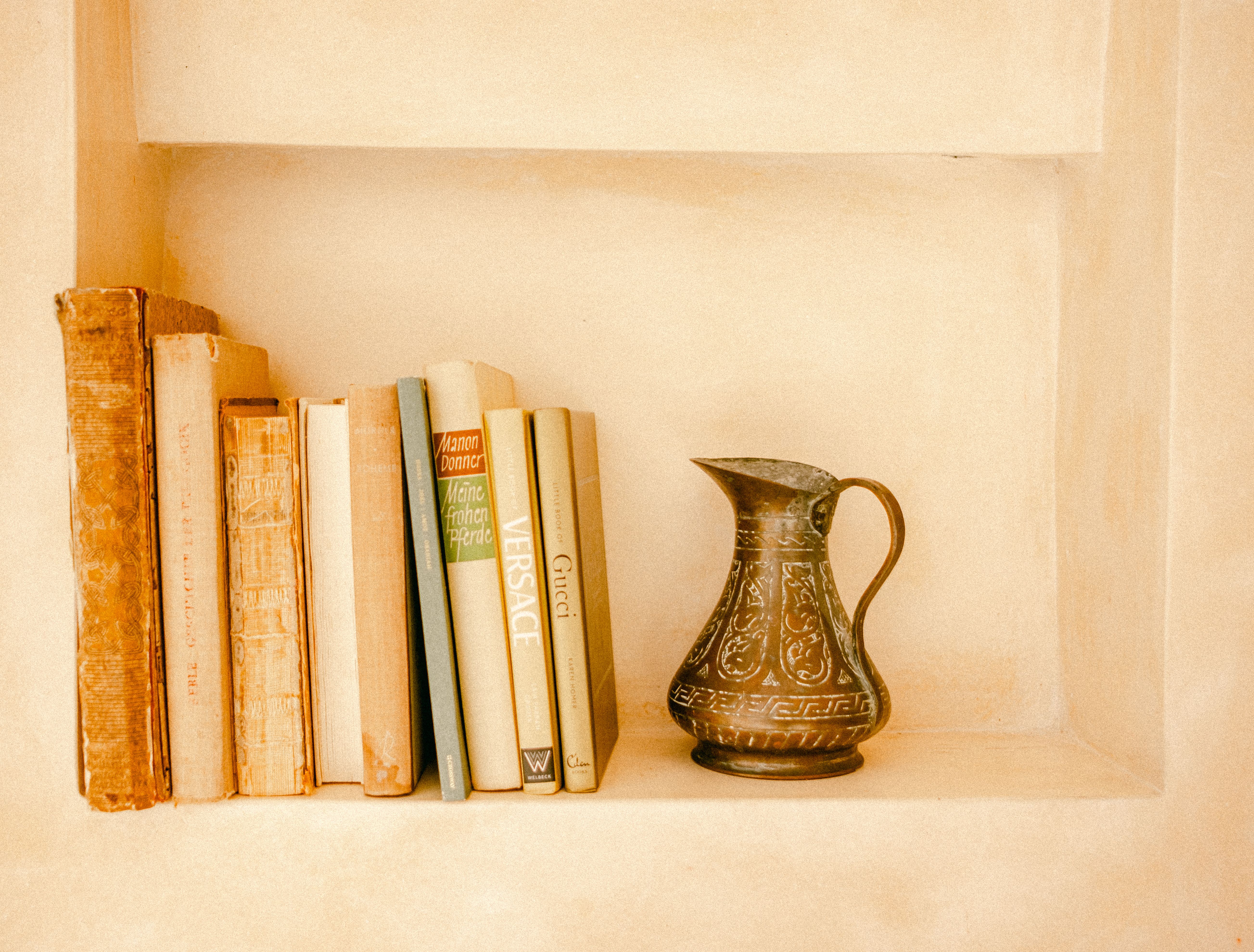 Compact foldable bookshelf in minimalist entryway with decorative items