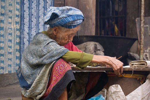 A Hmong woman weaving traditional textiles in Lung Tam, Hà Giang, Vietnam.