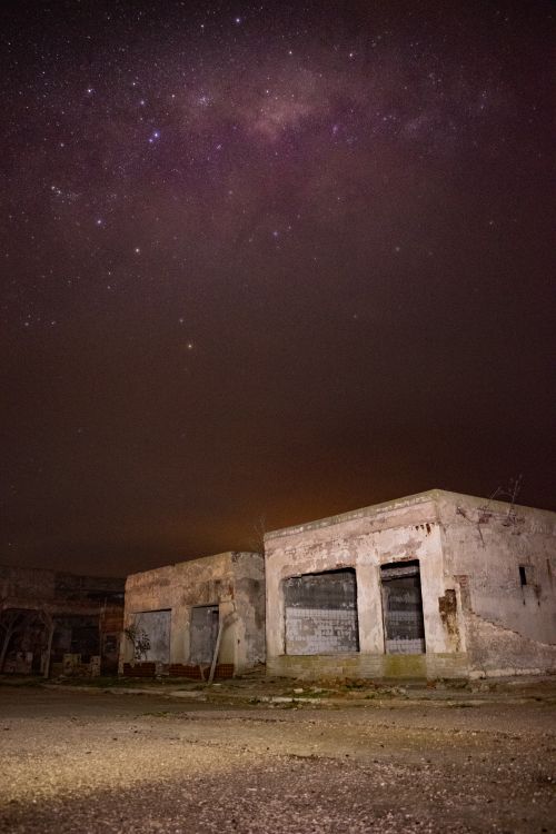 Free Explore the beauty of abandoned buildings beneath a stunning starry night sky with a vivid Milky Way view. Stock Photo