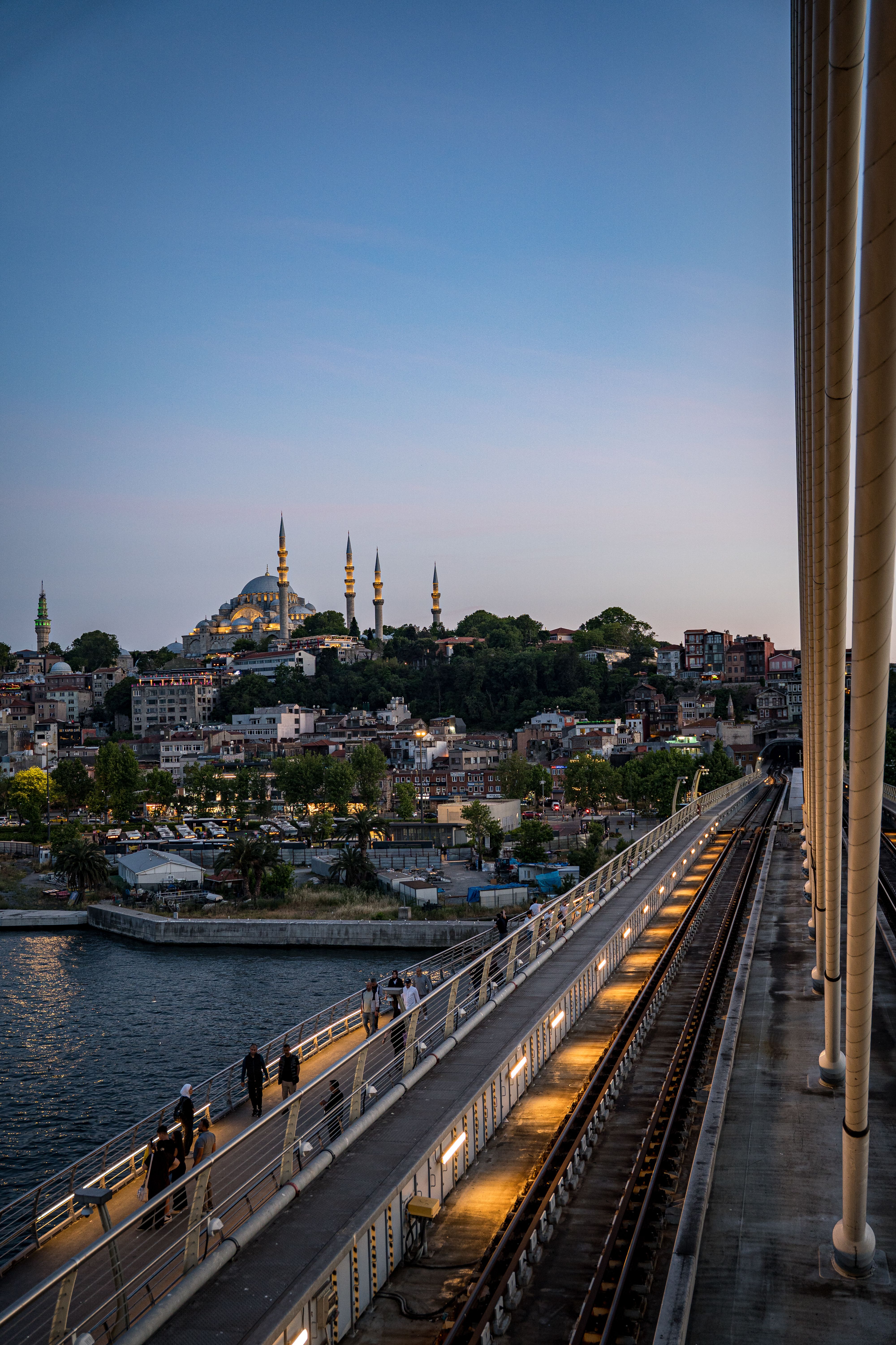 Captivating view of Istanbul's skyline featuring a mosque at dusk from a bridge.