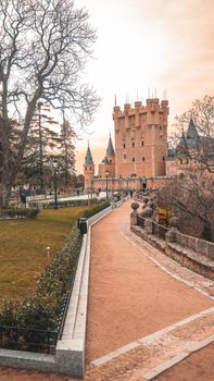 Stunning view of the Alcázar of Segovia in Spain captured during sunset with a warm, serene ambiance.