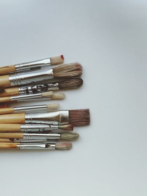 Free Minimalist arrangement of various brushes on a clean white surface. Stock Photo