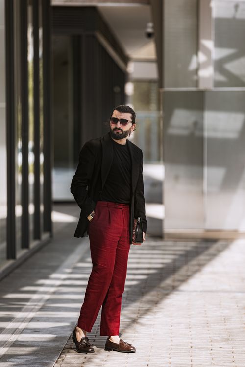 Free Fashionable man wearing red trousers and black jacket outdoors in Baku, Azerbaijan. Stock Photo