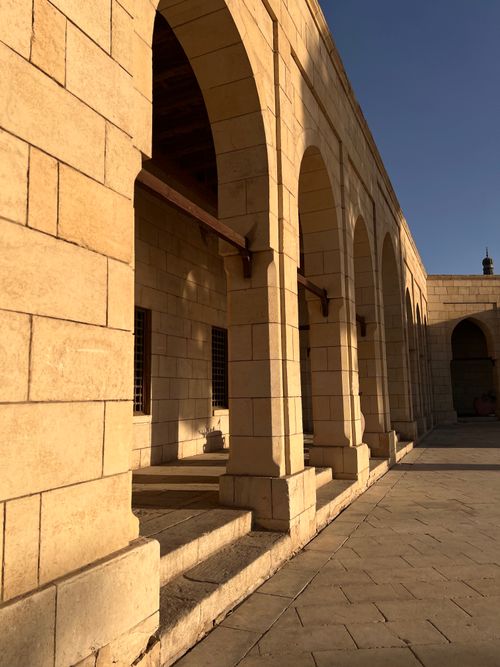 Free Sunlit stone arches in a historic building showcasing classic Egyptian architectural style. Stock Photo