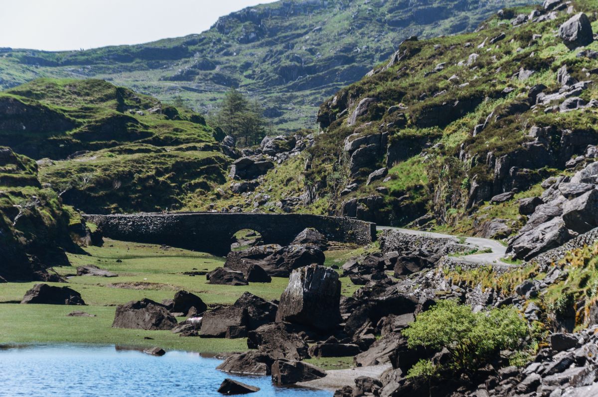 A scenic view of the Gap of Dunloe with a historic stone bridge