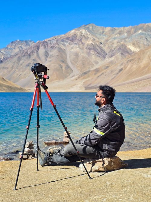 Free A photographer enjoys the view at Chandratal Lake in the Himalayas, Himachal Pradesh, India. Stock Photo