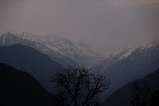Serene view of snow-capped mountains in Singtur Range, Uttarakhand at twilight.