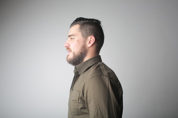 Serious Young Man In Classy Shirt In Studio