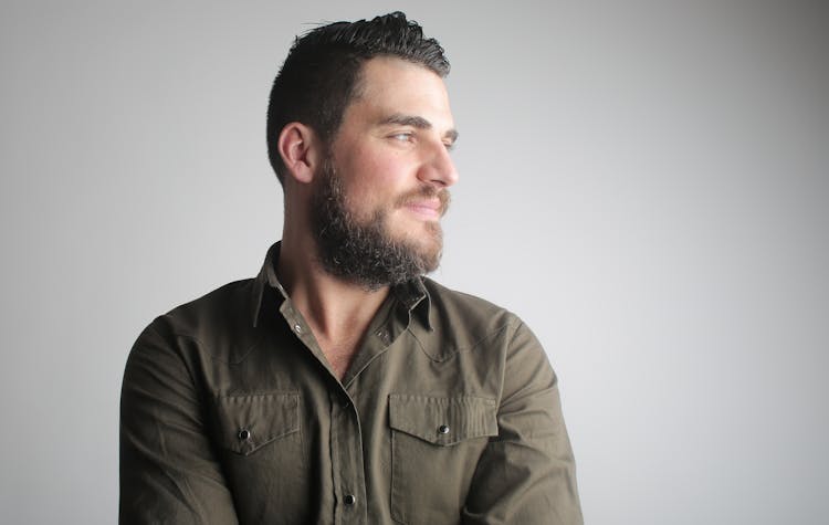 Smiling Brutal Man In Casual Shirt In Studio