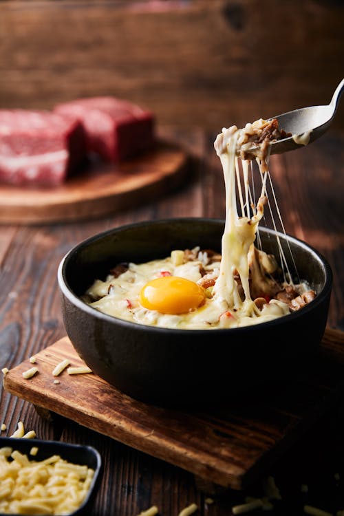 Stainless Steel Spoon on Black Ceramic Bowl