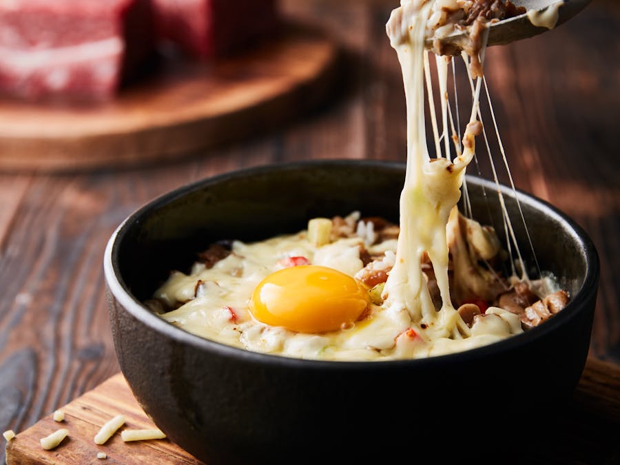 What does adding an extra egg to cheesecake do?
