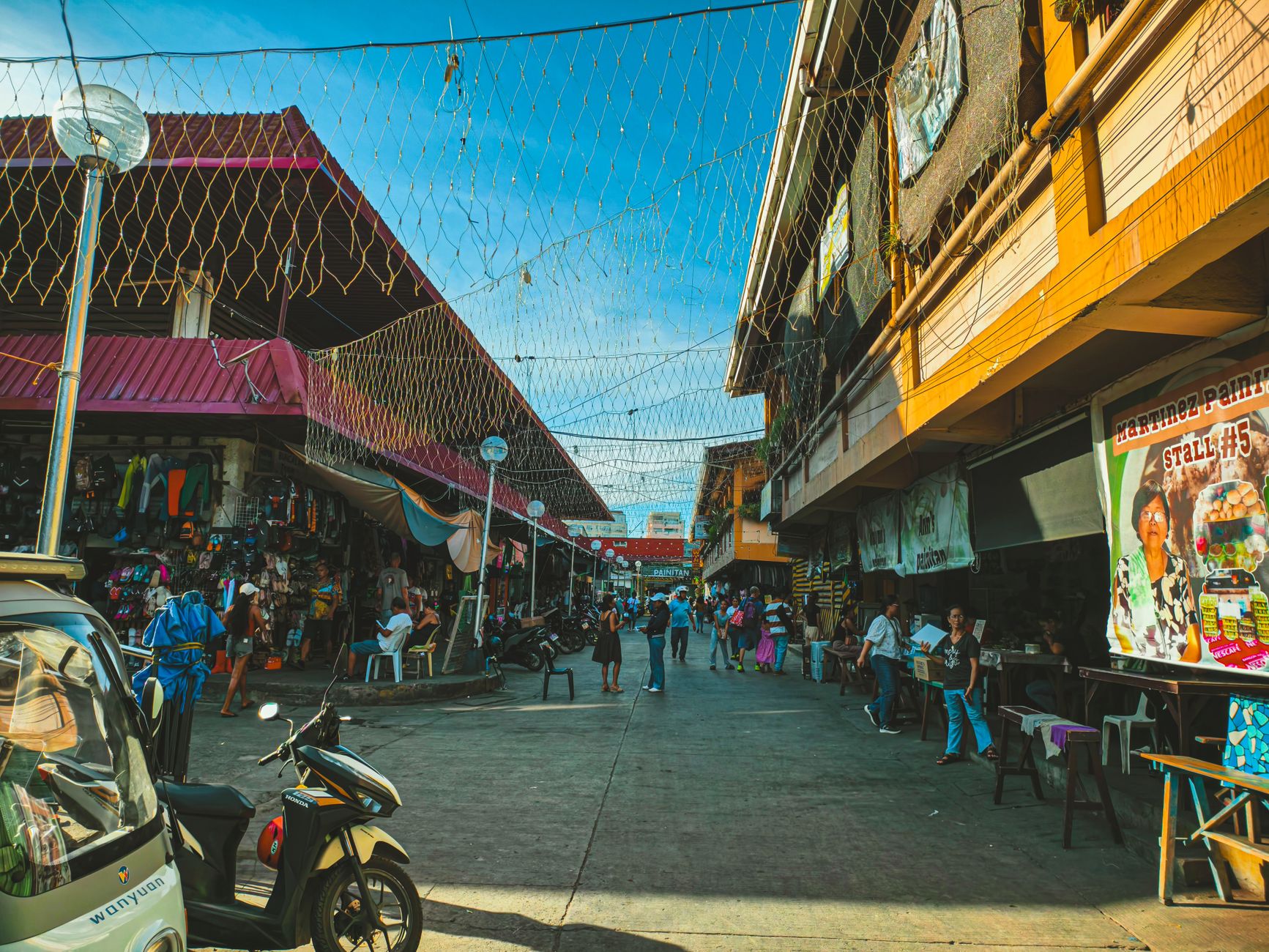 Explore the bustling street market in Dumaguete City with colorful stalls and lively atmosphere.
