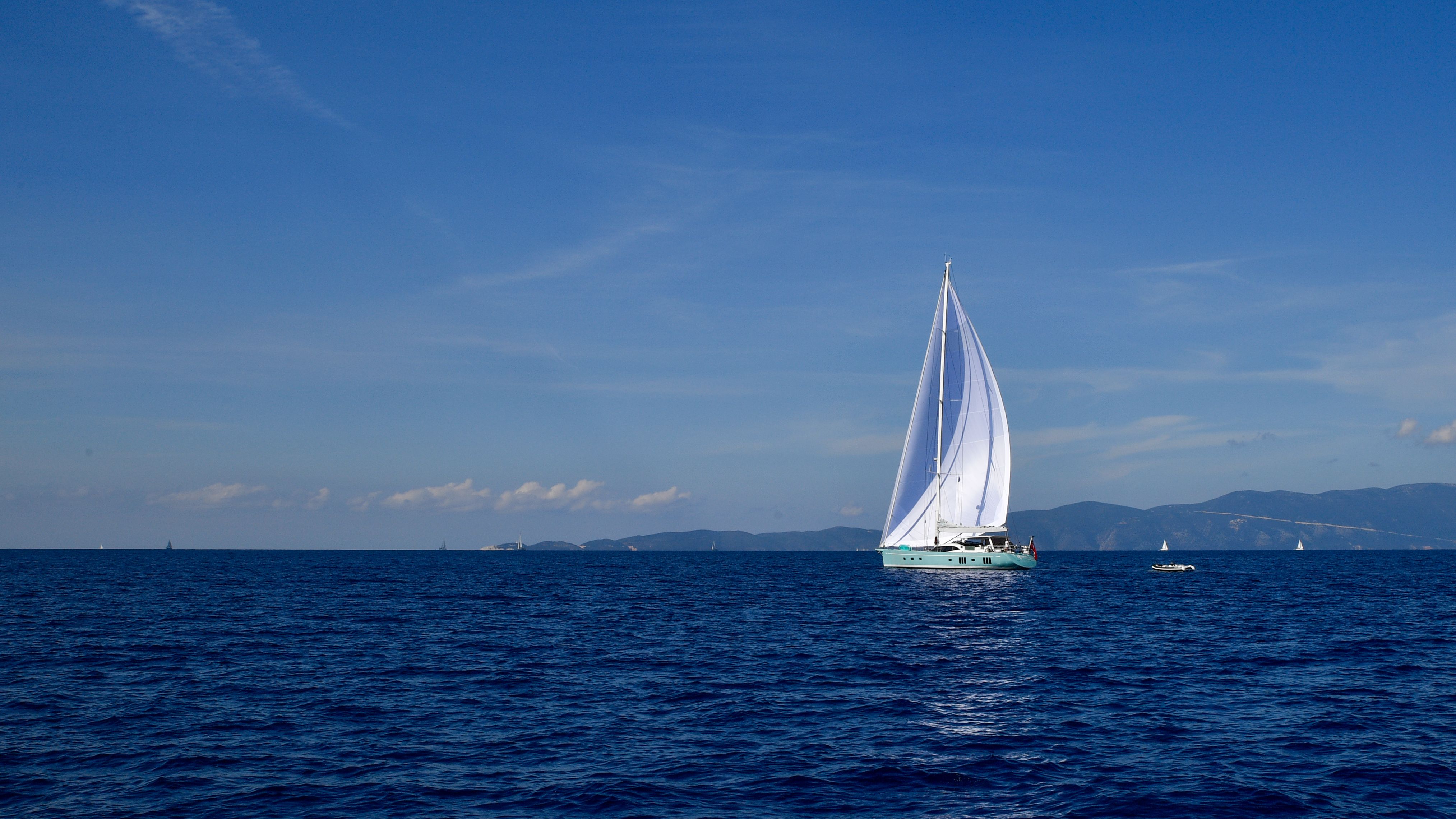 Breathtaking 3hr Luxury Private Sailing Catamaran in Waikiki for 1 to 6 People Review 2026 - A tranquil yacht cruising on deep blue waters under a clear summer sky.