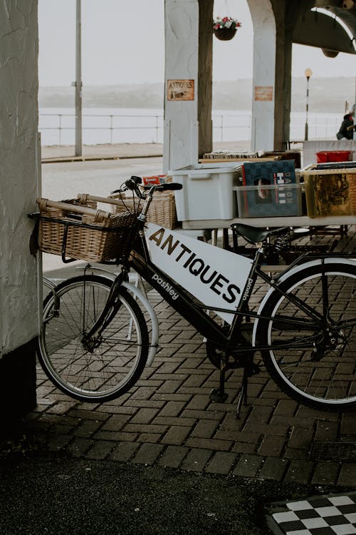 Black City Bike Parked Beside White Wall