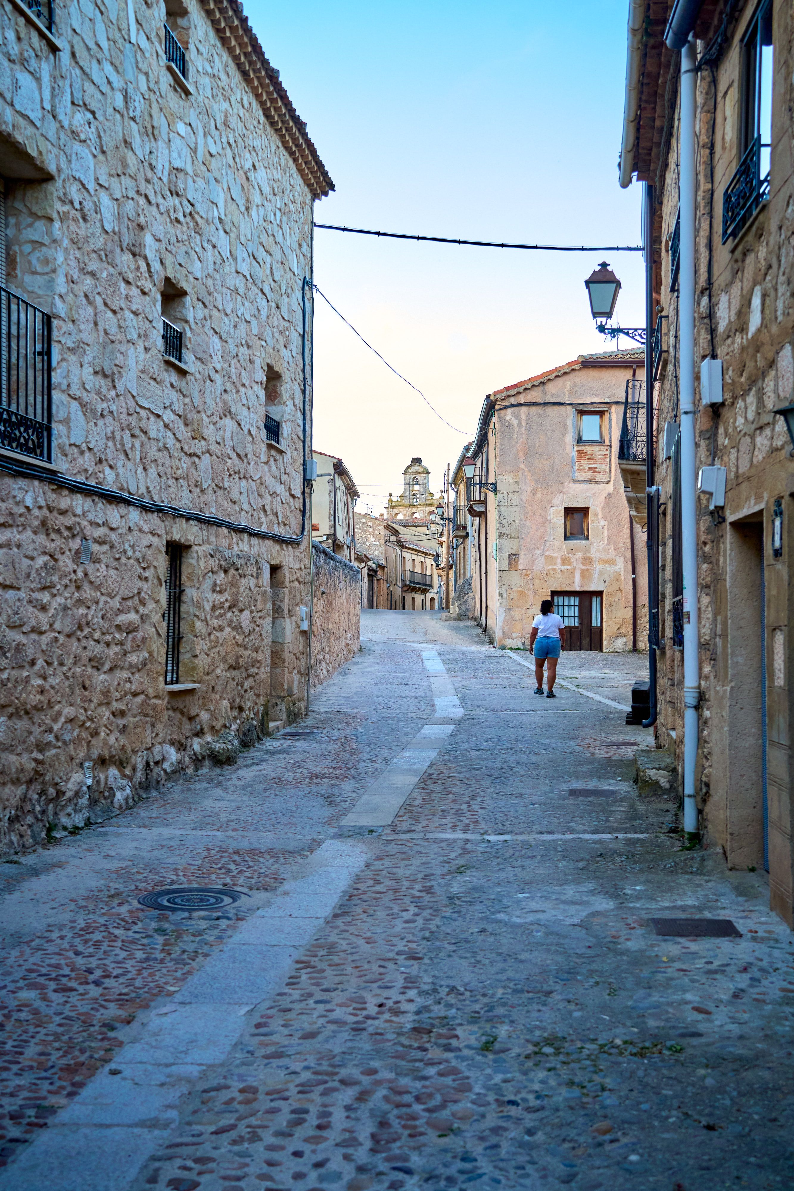 Picturesque stone street in Maderuelo, Castilla y León, Spain, showcasing historic architecture.