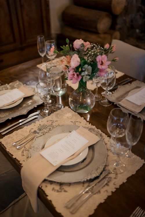 Free A beautifully arranged wedding reception table with floral centerpiece and elegant settings. Stock Photo