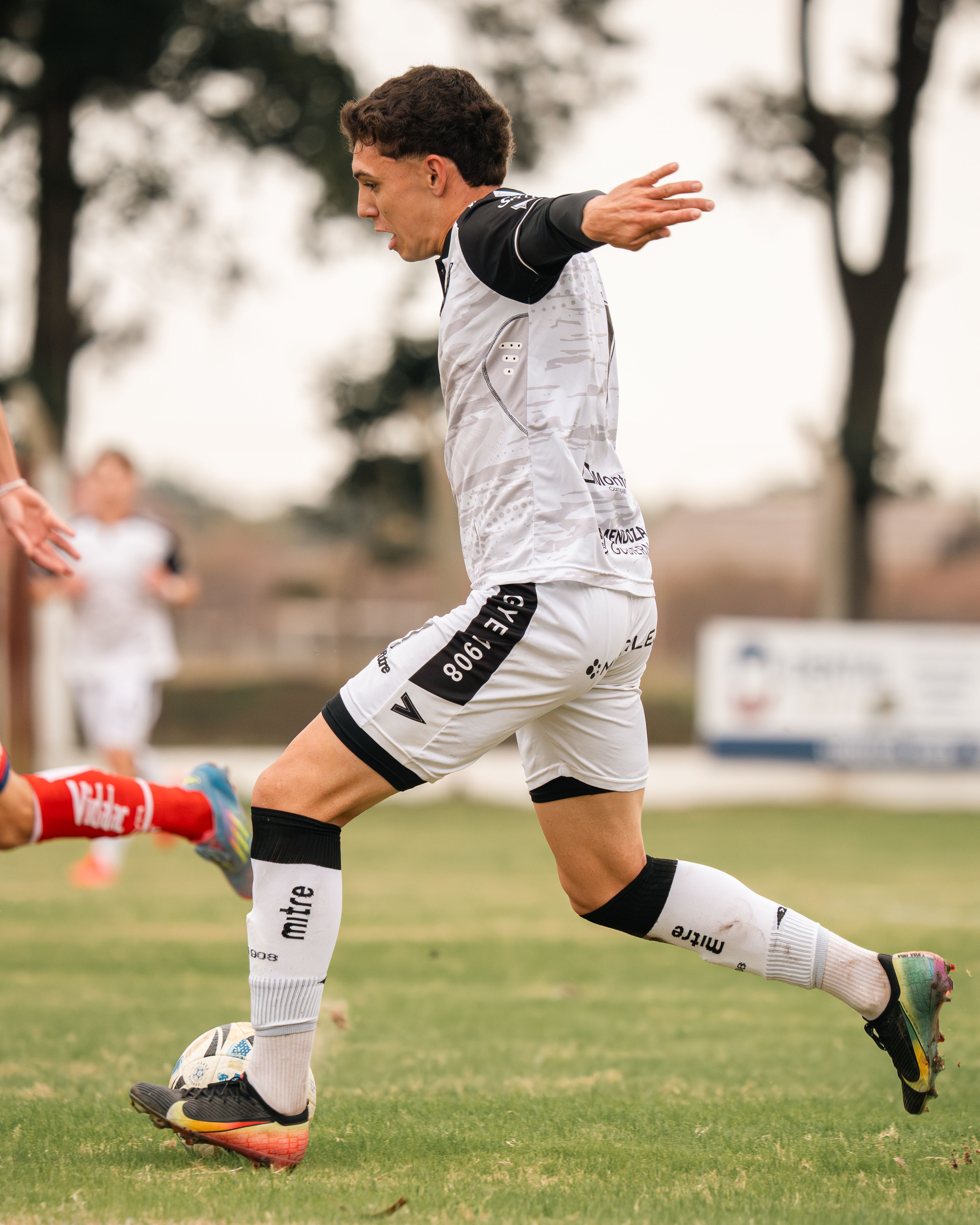 Dynamic shot of soccer players competing on an outdoor field. Perfect for sports themes.