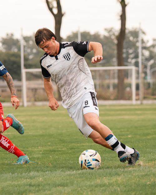 Free Intense soccer match with players in motion on a grassy field outdoors. Stock Photo