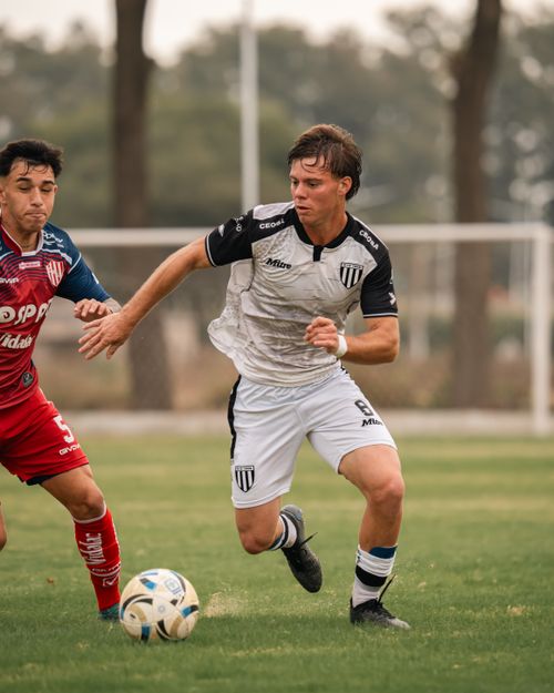 Free Two soccer players in intense competition on the field, demonstrating athleticism. Stock Photo