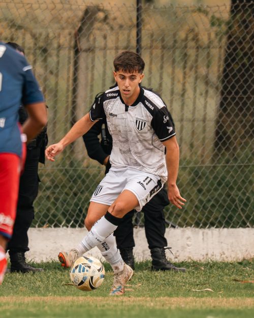 Free Young male soccer player dribbling during a match outdoors on a grass field. Stock Photo