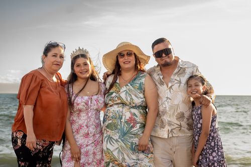 Free A family enjoying a sunny day at the beach, showcasing summer fashion. Stock Photo
