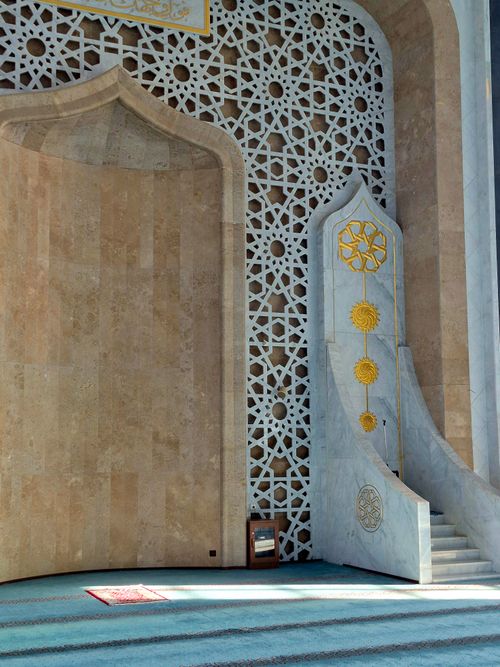 Free Detailed view of a mosque interior showcasing ornate Islamic geometric patterns and a mihrab. Stock Photo