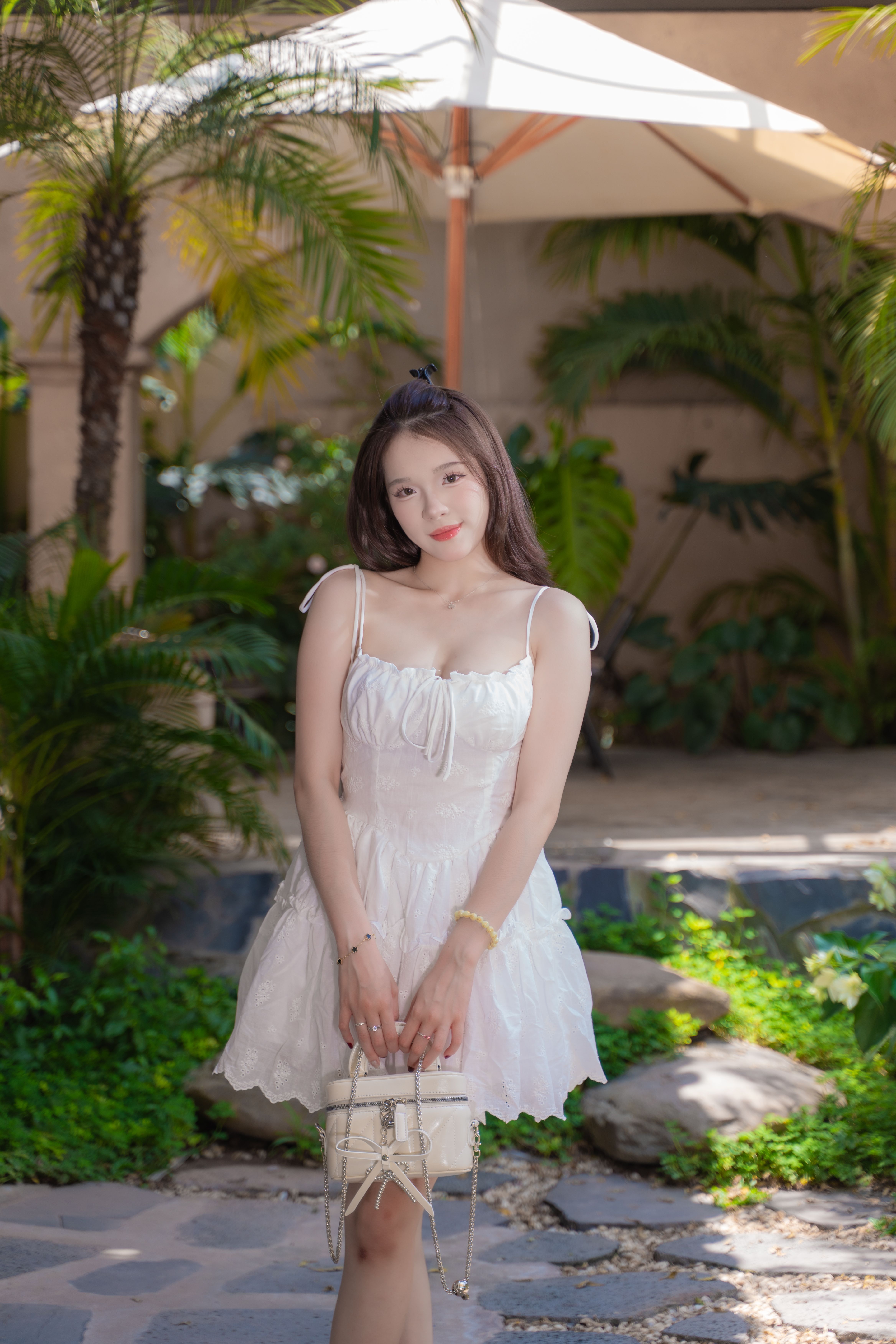 Elegant Woman in a Tropical Garden Setting