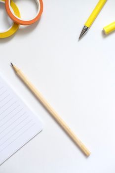 Simple flat lay of yellow office supplies on white background, perfect for creative projects.