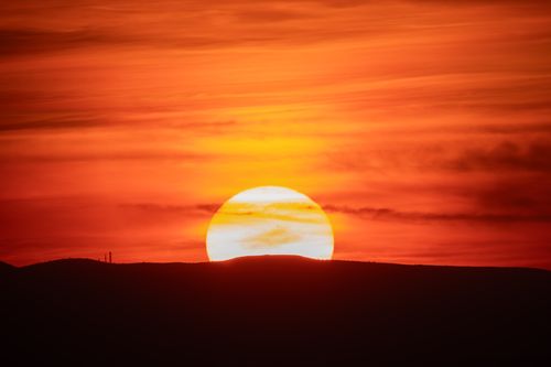 Free Spectacular sunset view over Ankara's hills with vibrant red and orange hues filling the sky. Stock Photo