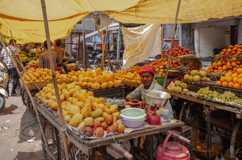 Free A bustling outdoor fruit market scene in Delhi, India showcasing fresh produce and vibrant culture. Stock Photo