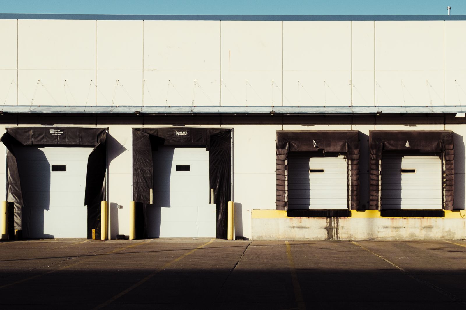 Closed bay doors at a loading dock, the warehouse entrance new hires find shut