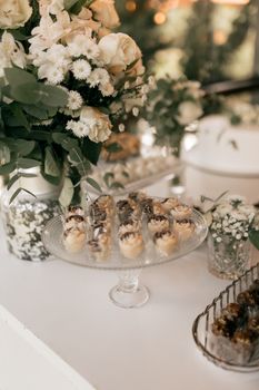 Beautifully arranged dessert table featuring flowers and pastries, perfect for weddings or celebrations.