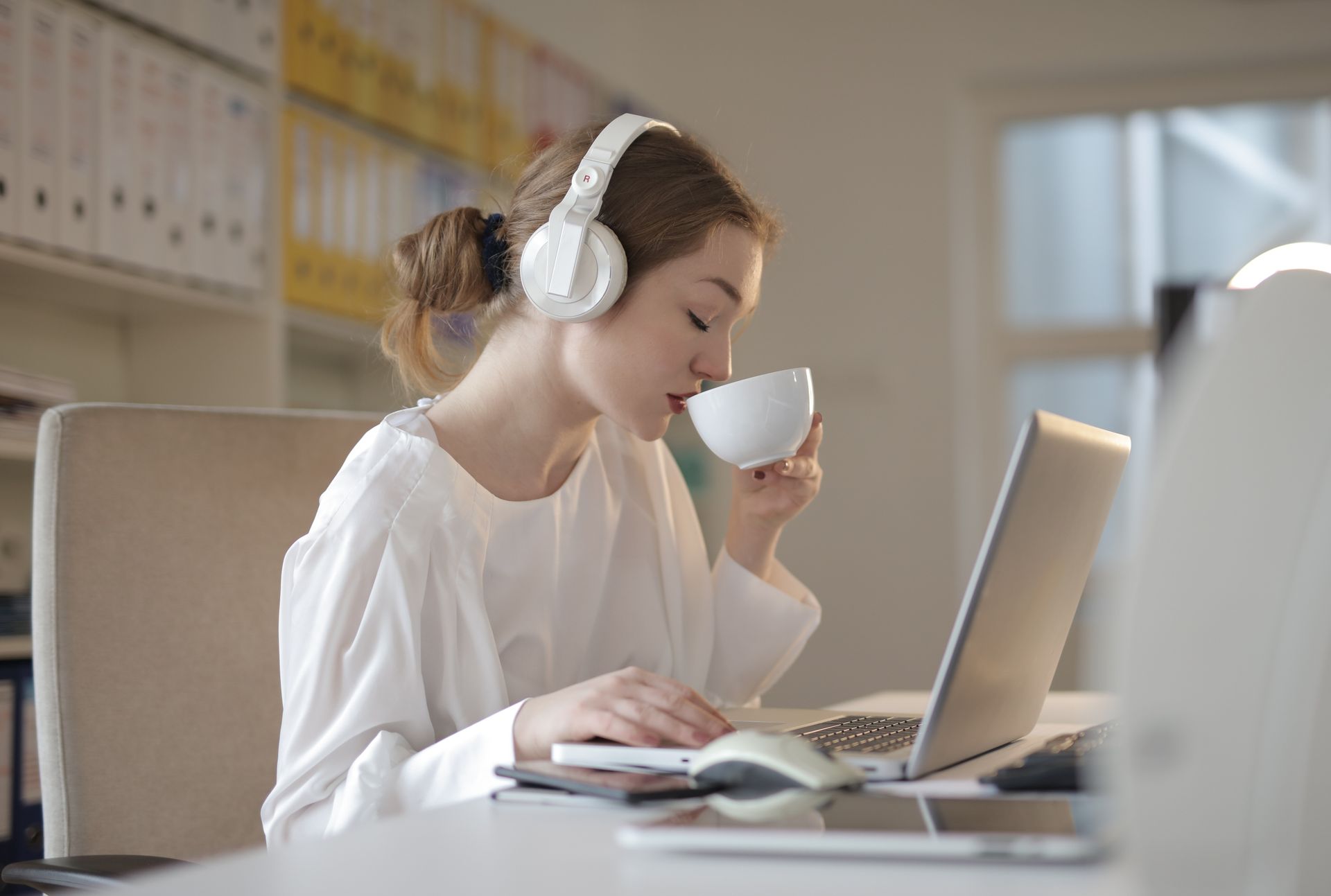 Woman in White Dress Shirt Using White Laptop Computer