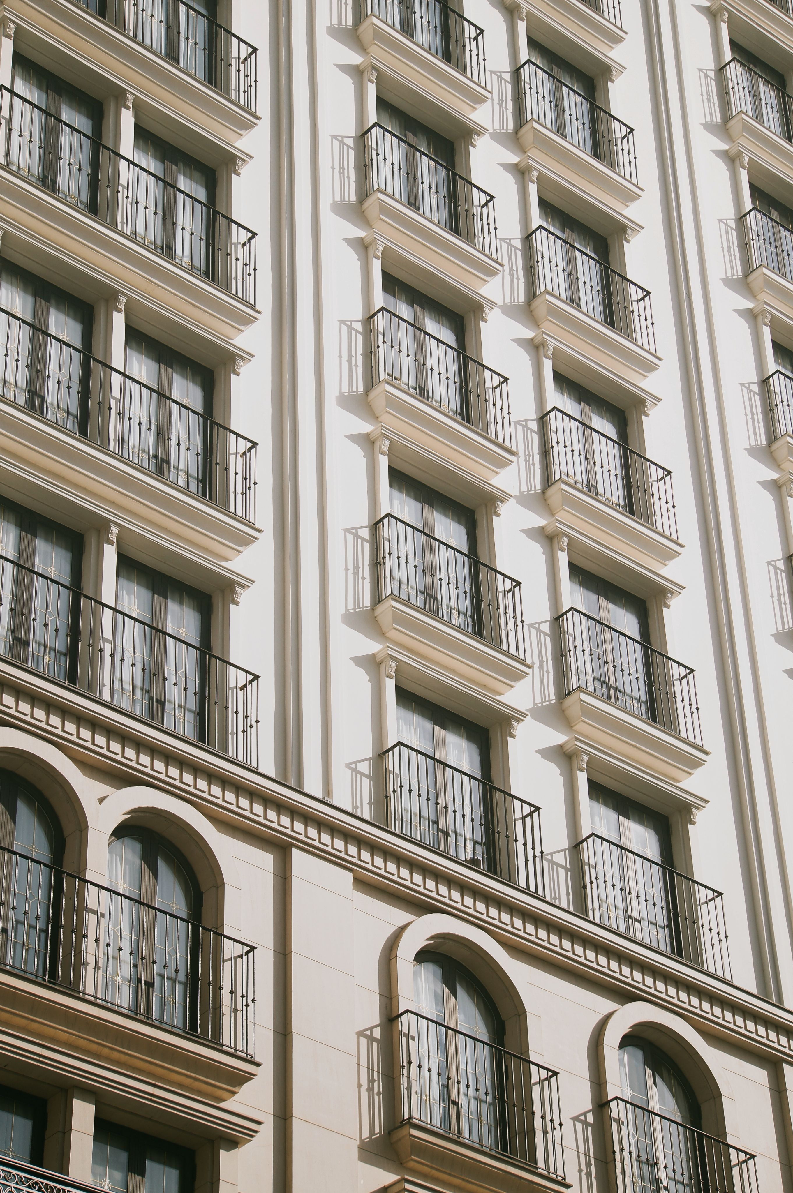 A sunlit view of a modern hotel facade with balconies in Da Nang, Vietnam.
