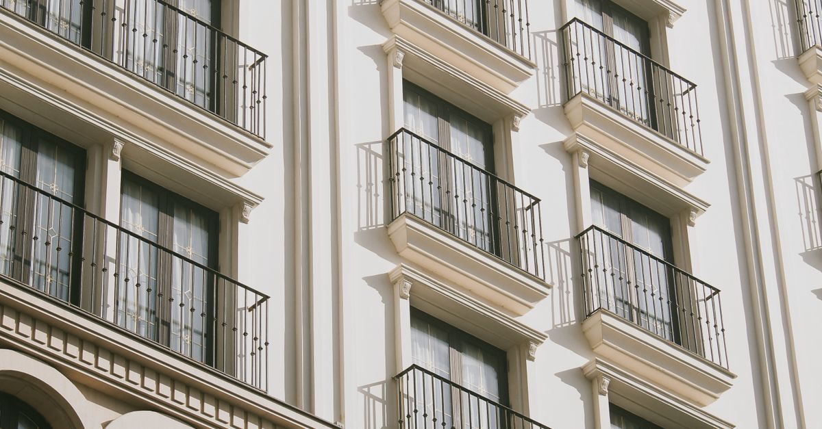 A sunlit view of a modern hotel facade with balconies in Da Nang, Vietnam.