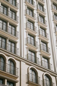 A sunlit view of a modern hotel facade with balconies in Da Nang, Vietnam.