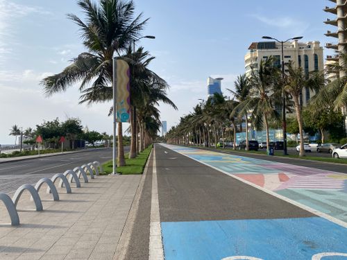Free Bright and colorful palm-lined road along Jeddah's coastline on a sunny day. Stock Photo