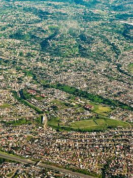 Aerial cityscape of Johannesburg showcasing dense urban development and greenery.