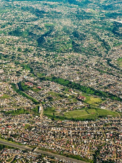 Free Aerial cityscape of Johannesburg showcasing dense urban development and greenery. Stock Photo