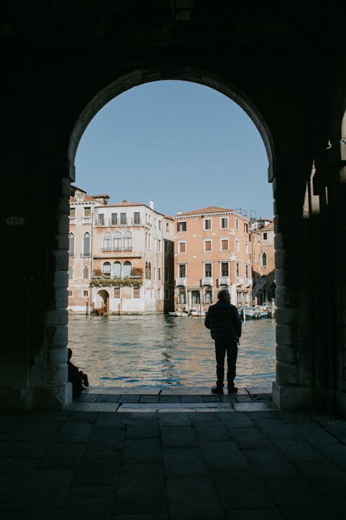 A Man Standing Beside Body of Water