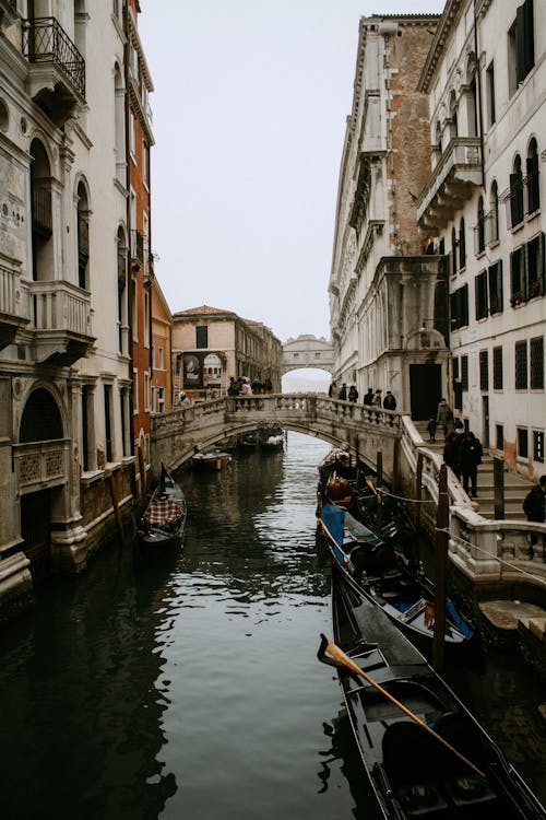 Boats on River Between Buildings