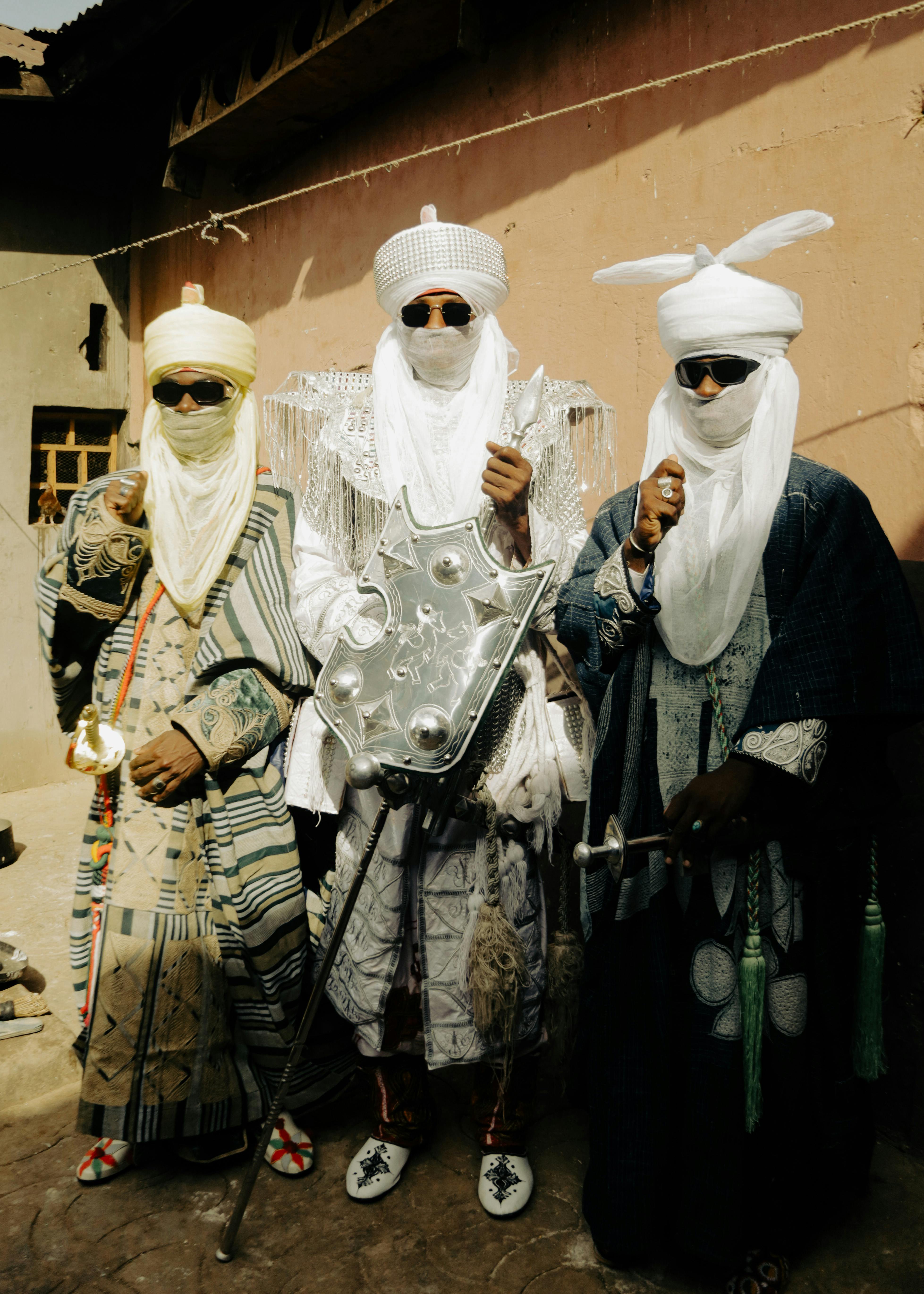 A vibrant depiction of three African warriors in traditional attire, showcasing cultural heritage.