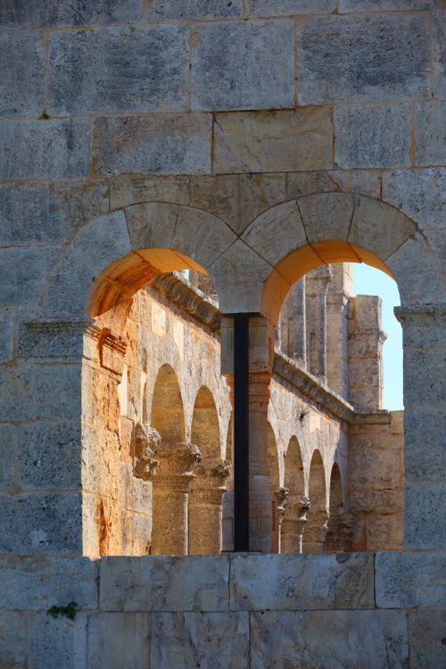 Free Captivating view of ancient stone arches and columns casting dramatic shadows. Stock Photo