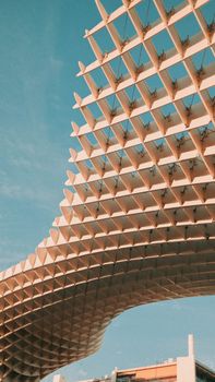 View of the Metropol Parasol's unique wooden architecture against a clear blue sky in Seville.