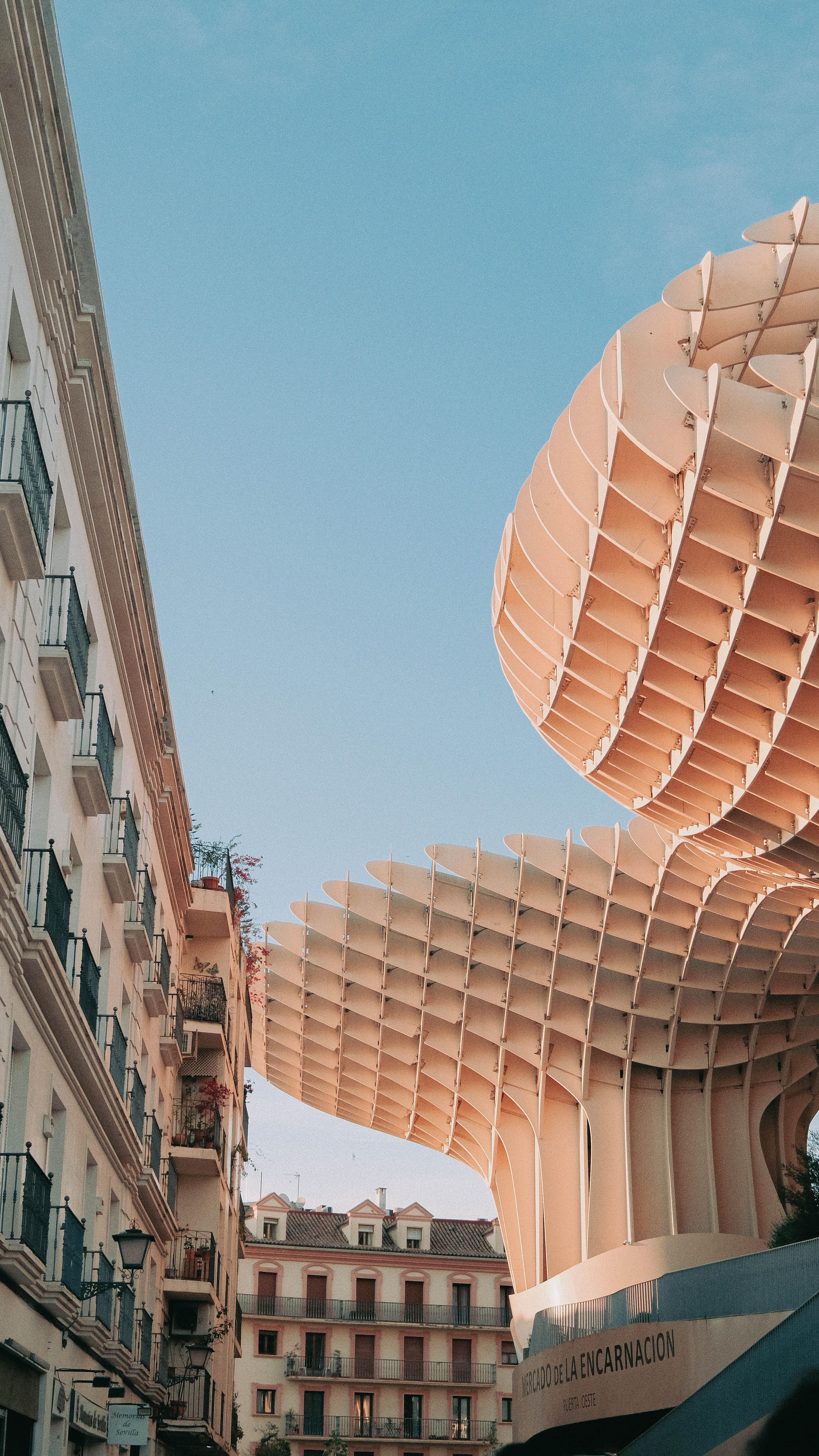 Stunning view of Seville's Metropol Parasol structure in contrast with historic buildings.